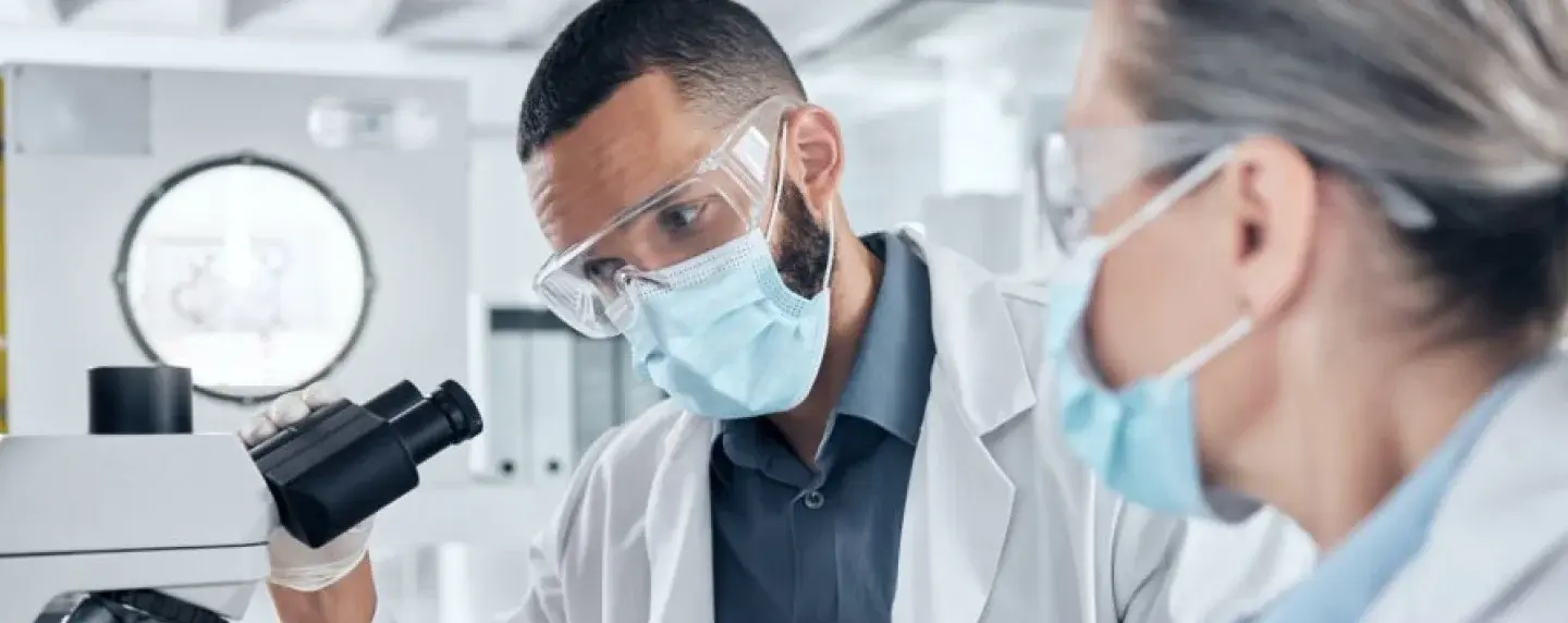 Image of two healthcare professionals working together to evaluate pathology specimen